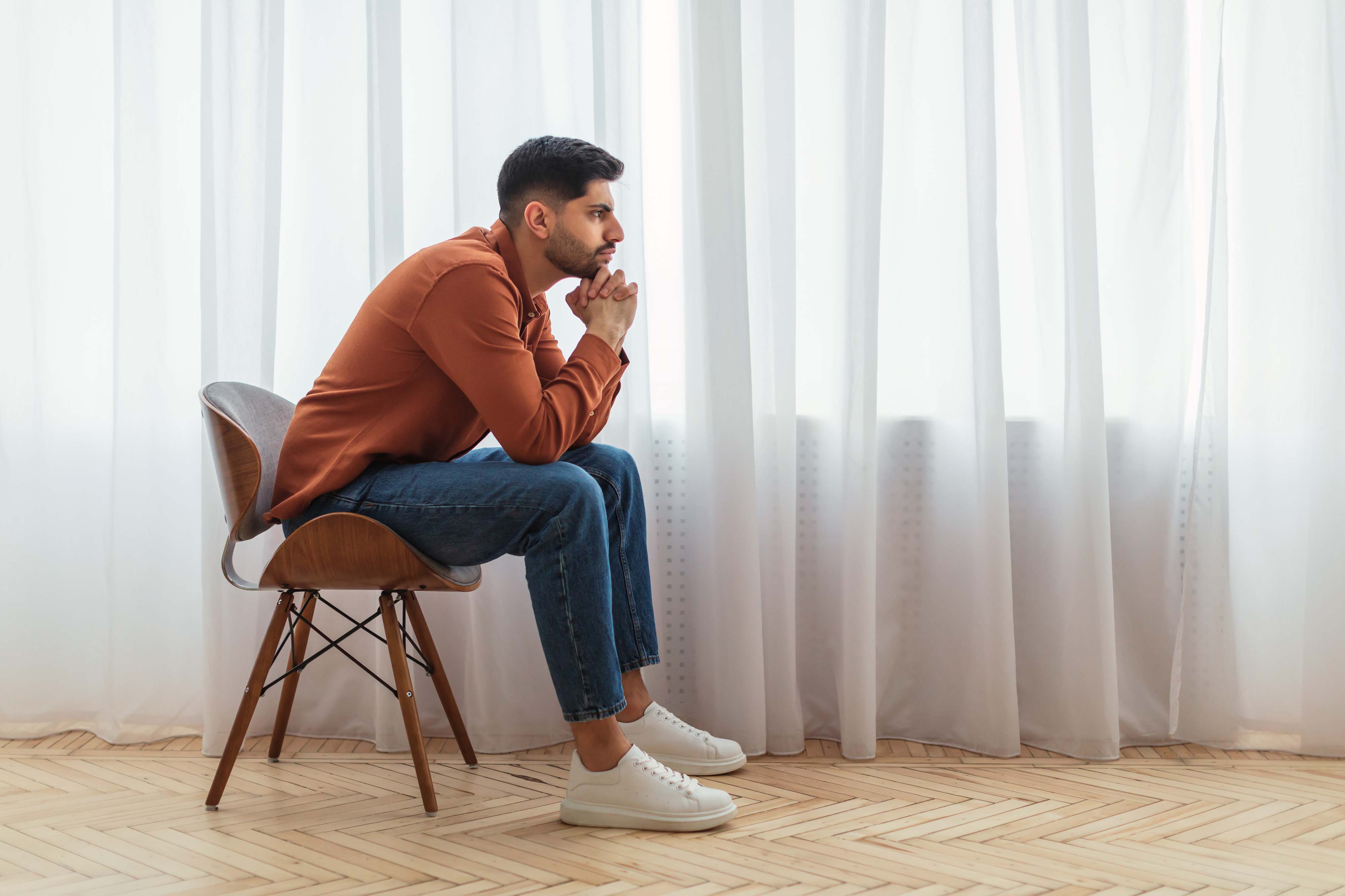 Bored person sitting alone